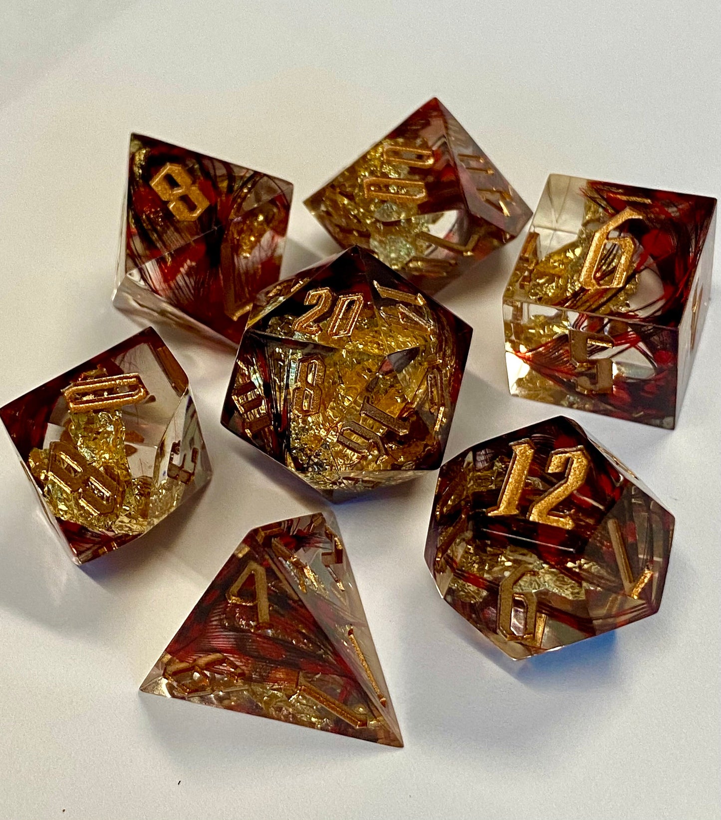 With Wings -Ruby -Premium Sharp Edge Dice Set- Clear Resin w/ Red Feathers and Golden Flakes-Gold Ink- Dungeons& Dragons, TTRPGs, Pathfinder