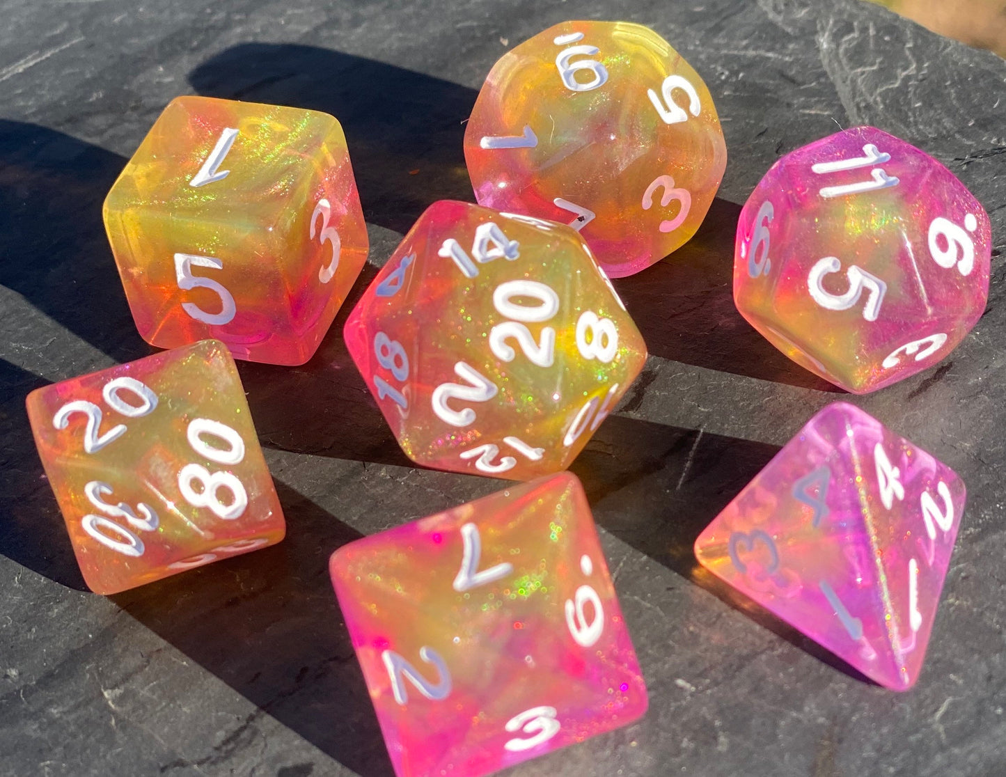 Feather Fall - 7 piece acrylic dice set-glittering blend of yellows and purples with shimmering glitter dust.