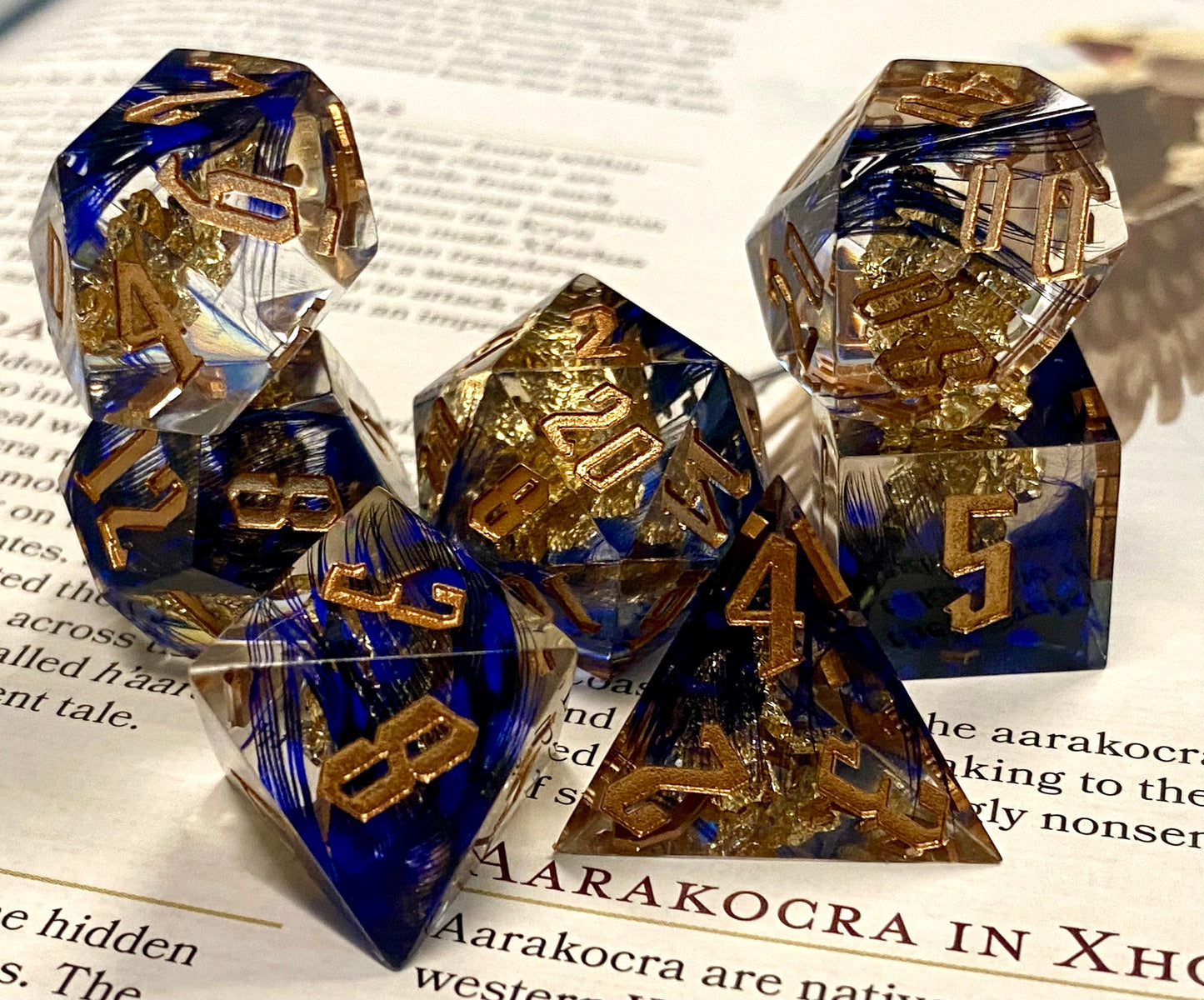 With Wings - Premium Sharp Edge Dice Set- Clear Resin w/ Blue Feathers and Golden Flakes-Gold Ink- Dungeons & Dragons, TTRPGs, Pathfinder